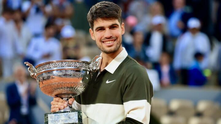 Spain's Carlos Alcaraz holds the winner's trophy after beating  Italy's Jannik Sinner for the men's singles title at the French Open in Paris, Sunday 6 June, 2025.